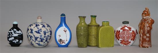 Eight Chinese porcelain snuff bottles, one slip decorated with cranes on a black ground and another in literati style, blue ground